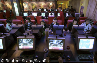 People use computers inside an Internet cafe in China